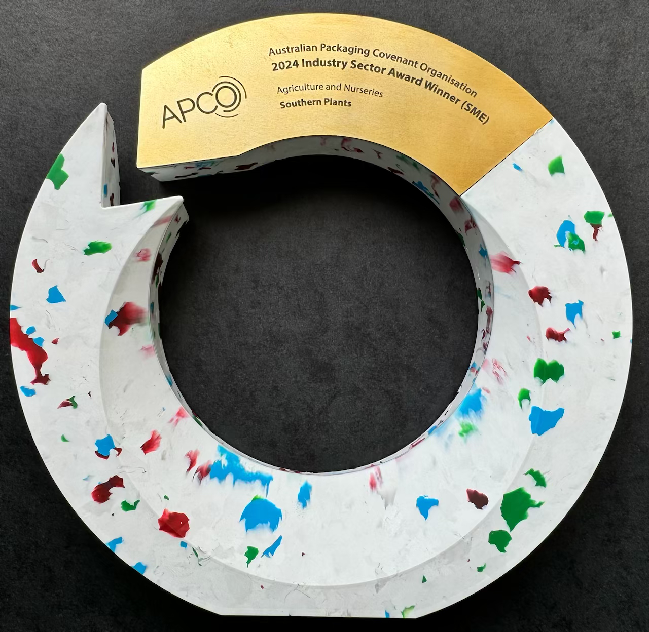 The APCO 2024 Industry Sector Award trophy, a white speckled ring with a gold plaque naming Southern Plants as the Agriculture and Nurseries (SME) winner